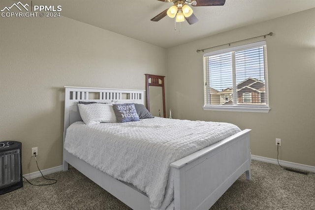 bedroom featuring ceiling fan and dark carpet