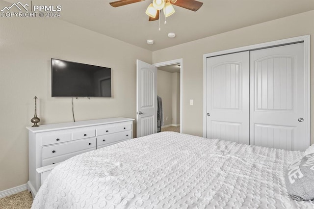 carpeted bedroom featuring a closet and ceiling fan