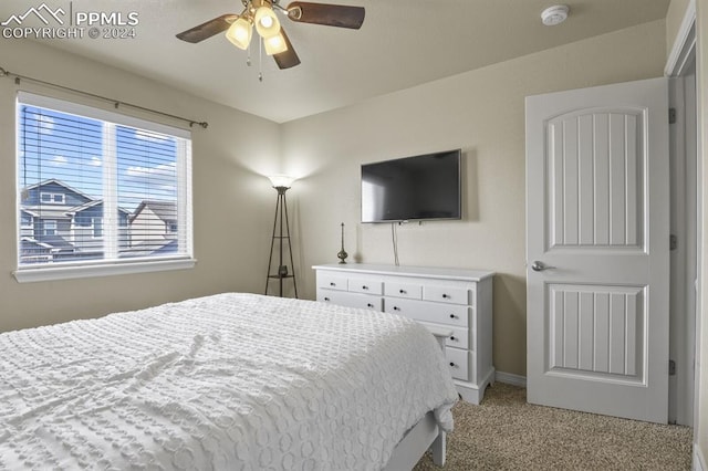 carpeted bedroom with ceiling fan