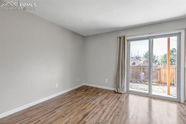 unfurnished room featuring light wood-type flooring and a healthy amount of sunlight