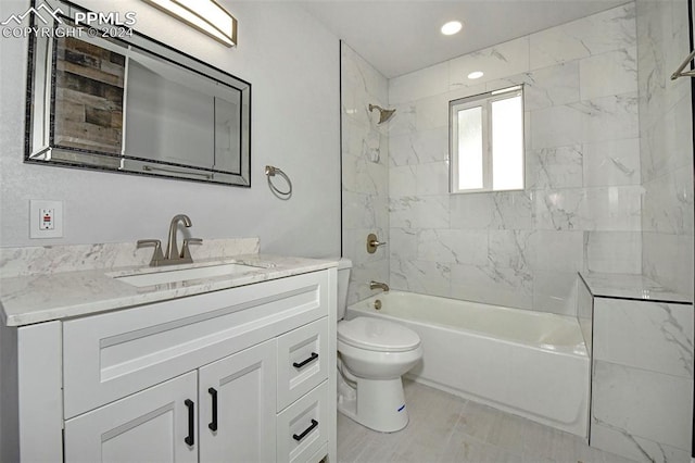 full bathroom with vanity, tiled shower / bath, and toilet