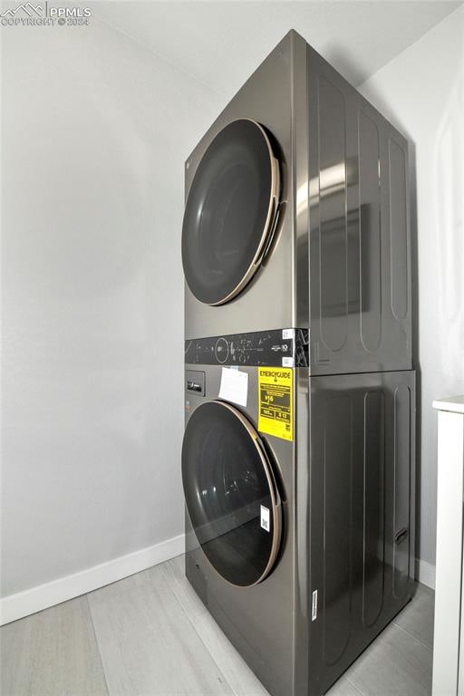 laundry area with stacked washing maching and dryer