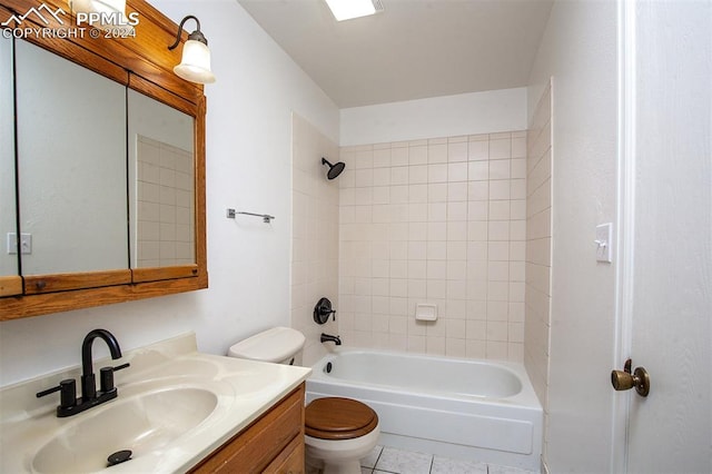 full bathroom with toilet, tiled shower / bath combo, vanity, and tile patterned flooring