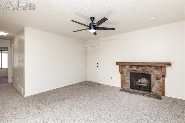 unfurnished living room with carpet floors, a textured ceiling, a fireplace, and ceiling fan