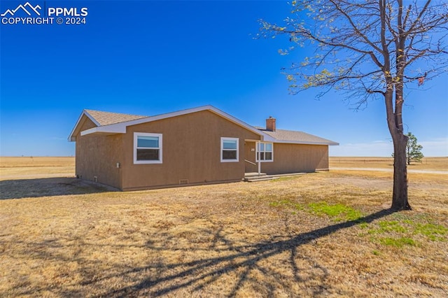 rear view of property with a rural view