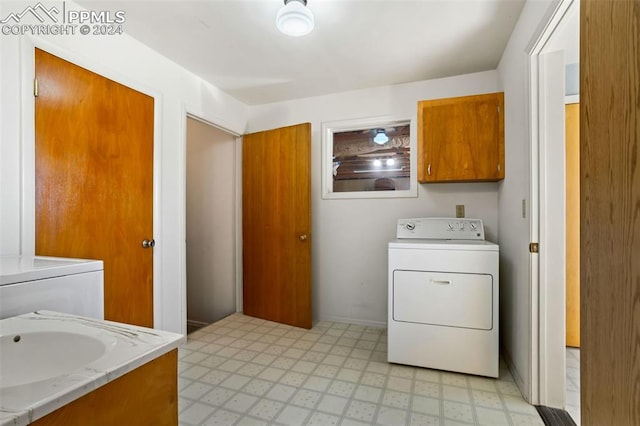 laundry area with washer / dryer and cabinets