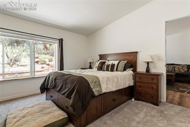 carpeted bedroom featuring lofted ceiling