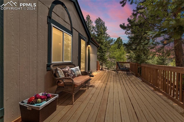 deck at dusk with an outdoor hangout area