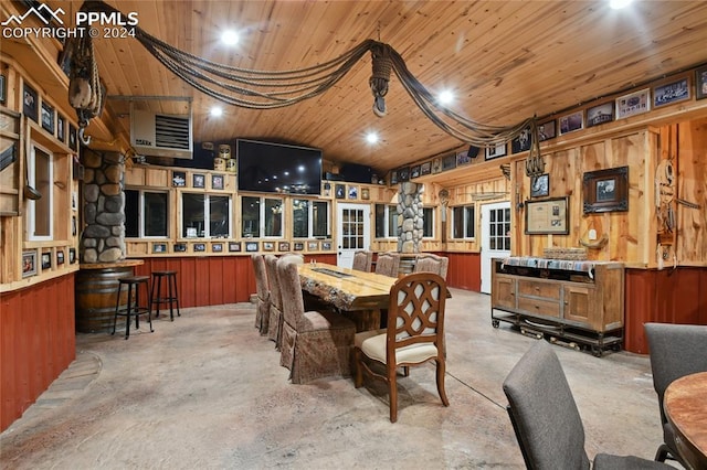 dining space featuring wooden walls and wood ceiling