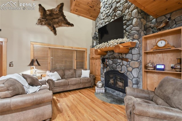 living room with a stone fireplace, high vaulted ceiling, wood-type flooring, and wood ceiling