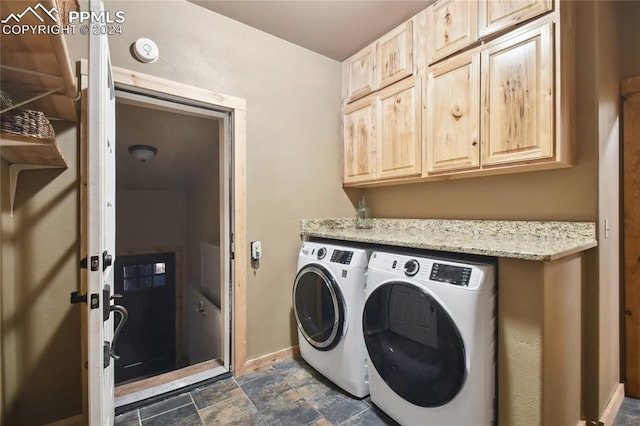 laundry room featuring cabinets and washer and dryer