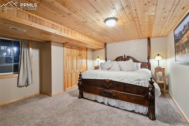 bedroom featuring wooden ceiling and carpet floors