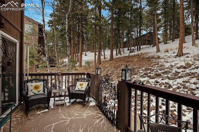 view of snow covered back of property