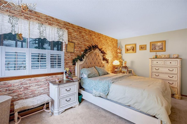 bedroom with light carpet and brick wall