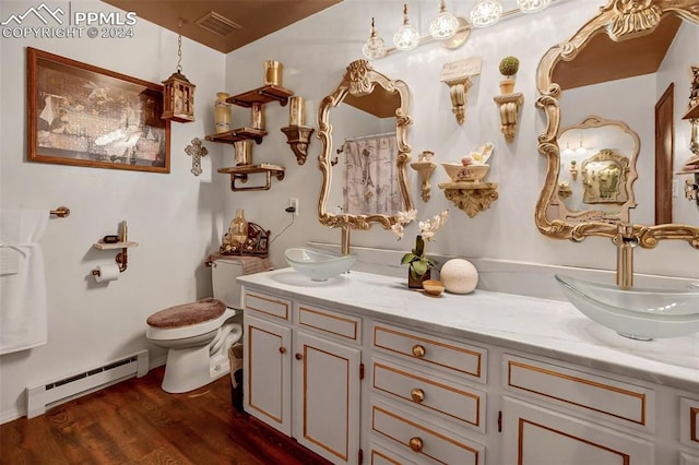 bathroom featuring hardwood / wood-style flooring, a shower with curtain, vanity, a baseboard radiator, and toilet