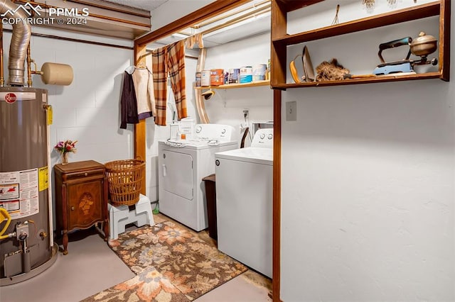 clothes washing area featuring water heater and separate washer and dryer