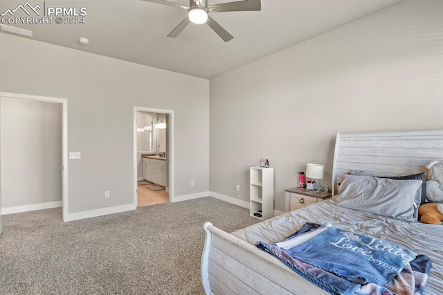 carpeted bedroom with ensuite bathroom and ceiling fan