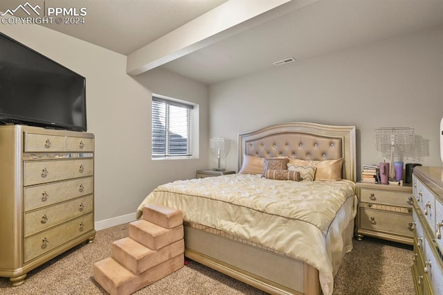 carpeted bedroom featuring beam ceiling