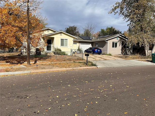 view of front of house with solar panels and a garage