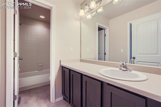 full bathroom with tiled shower / bath, vanity, toilet, and tile patterned floors