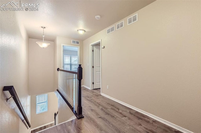 corridor with light hardwood / wood-style floors