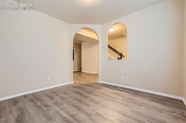 spare room with hardwood / wood-style floors