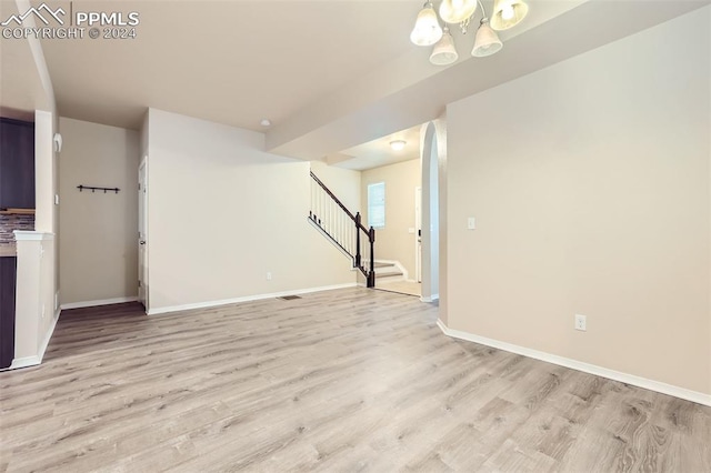 interior space with light hardwood / wood-style flooring and an inviting chandelier