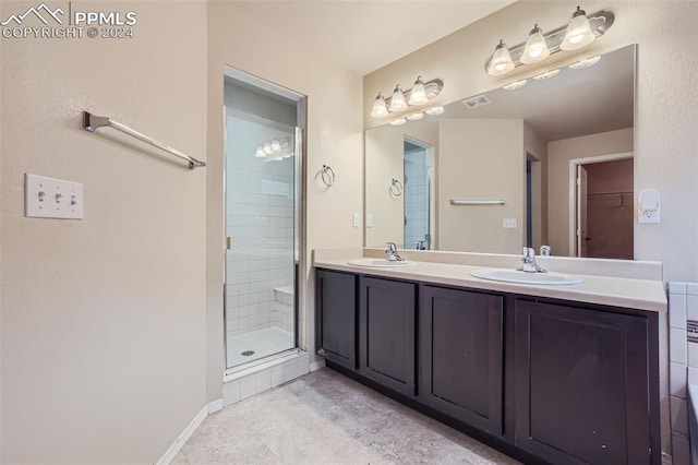 bathroom featuring vanity, tile patterned floors, and a shower with door