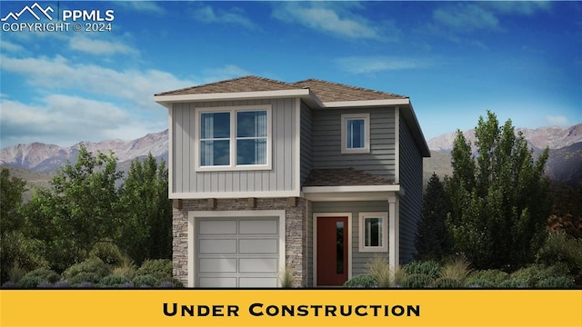 view of front of home with a mountain view and a garage