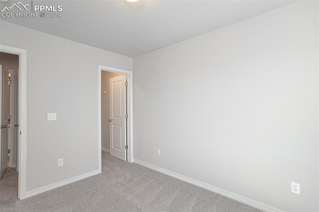 unfurnished bedroom featuring light colored carpet