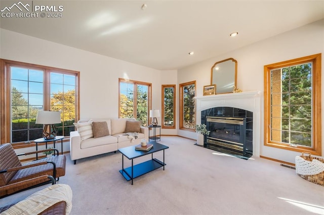 carpeted living room with a tile fireplace