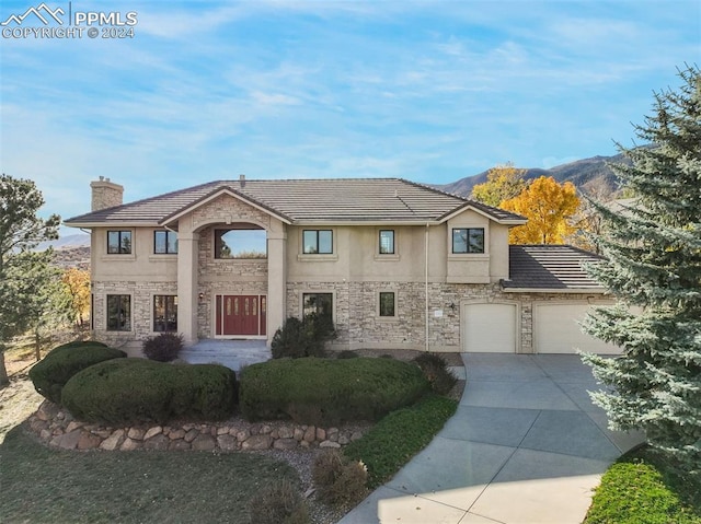 view of front of home with a mountain view and a garage