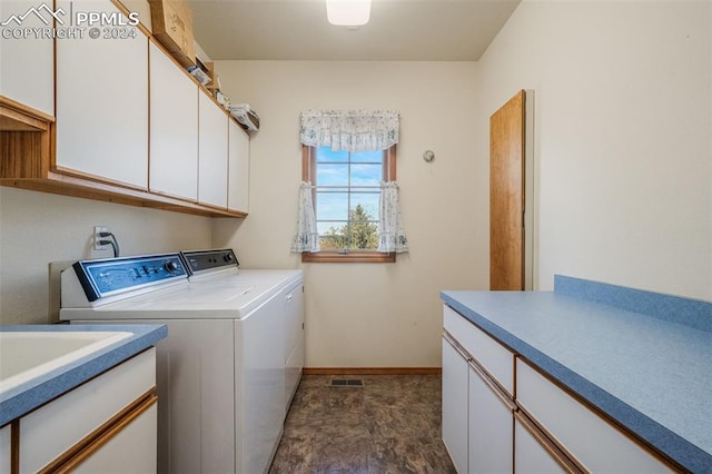 laundry area with cabinets and separate washer and dryer