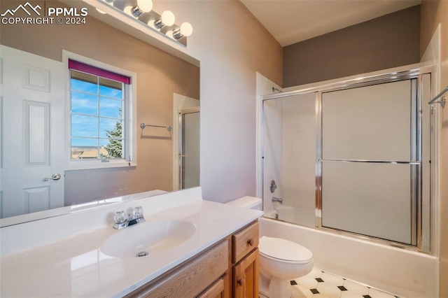 full bathroom featuring vanity, toilet, and combined bath / shower with glass door