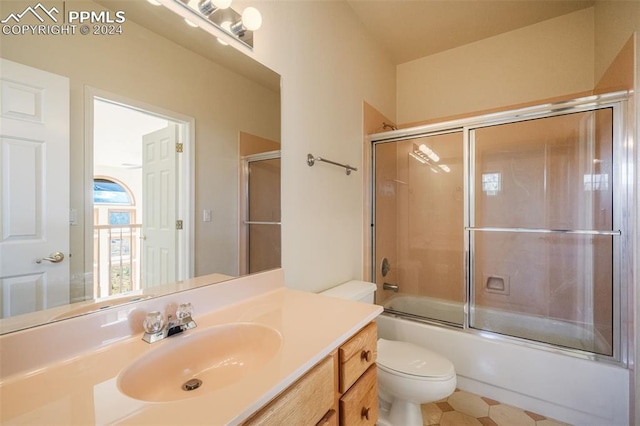 full bathroom featuring vanity, enclosed tub / shower combo, and toilet