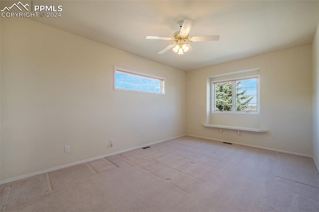 carpeted empty room with ceiling fan