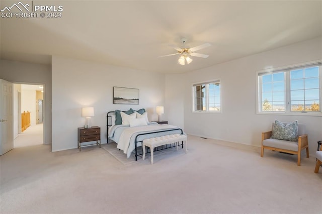 bedroom with ceiling fan and light carpet