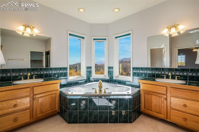 bathroom featuring vanity, decorative backsplash, and a relaxing tiled tub