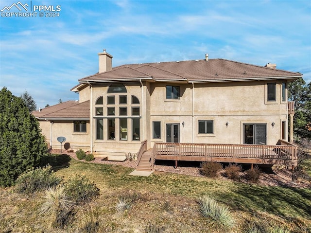 back of house with a wooden deck