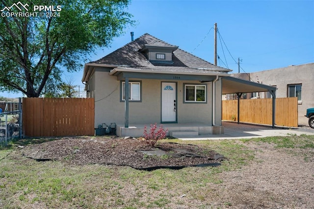 bungalow with covered porch and a carport