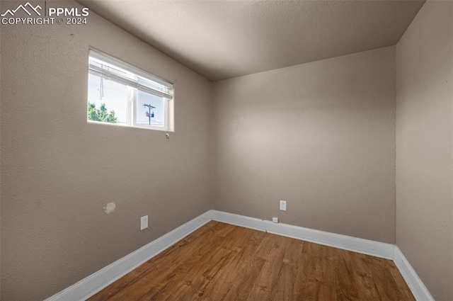 unfurnished room with wood-type flooring