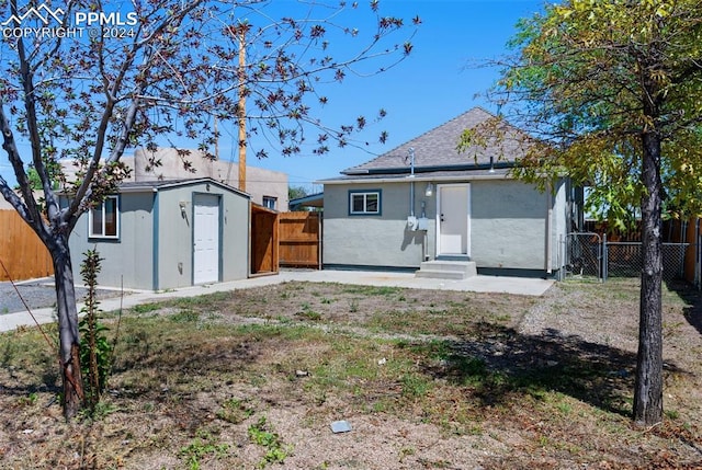 back of property with a shed