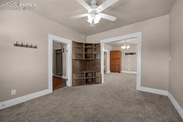 interior space featuring ceiling fan with notable chandelier