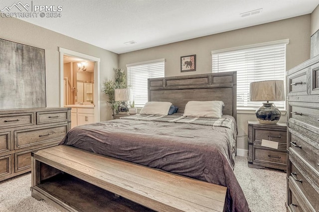 carpeted bedroom with ensuite bath