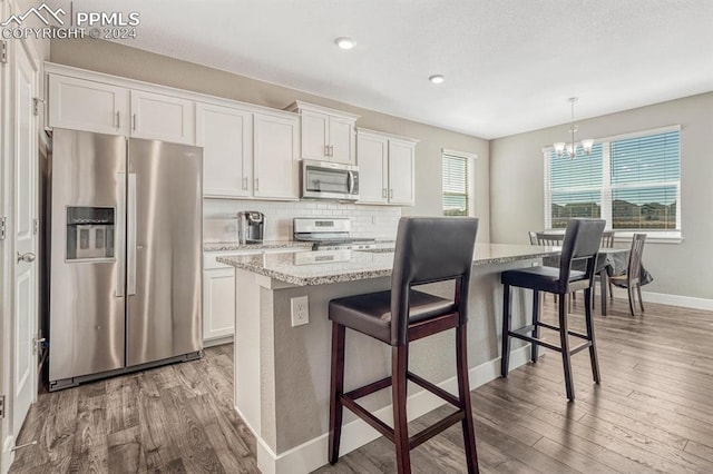 kitchen featuring white cabinetry, a healthy amount of sunlight, and stainless steel appliances