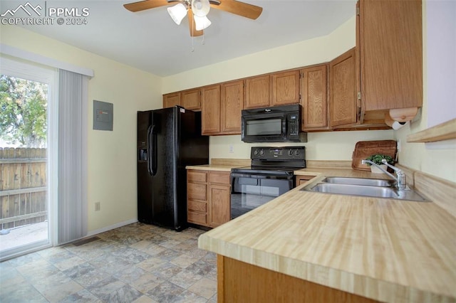 kitchen with ceiling fan, electric panel, black appliances, and sink