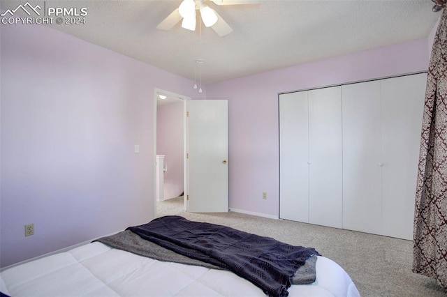 bedroom featuring a closet, ceiling fan, and light colored carpet