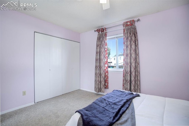 carpeted bedroom featuring a closet and ceiling fan