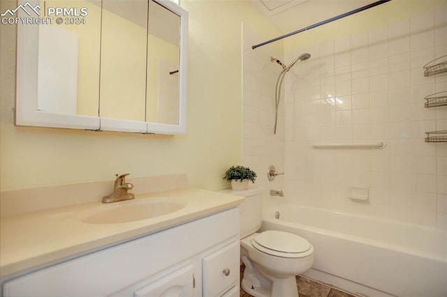 full bathroom featuring vanity, toilet, tiled shower / bath combo, and tile patterned flooring