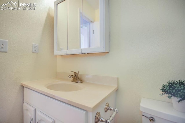 bathroom with toilet and vanity